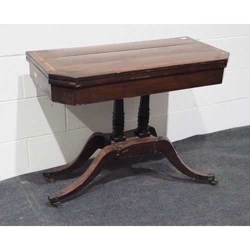 154 - Victorian mahogany swivel top folding games table with inlay, pedestal base and on brass casters 36