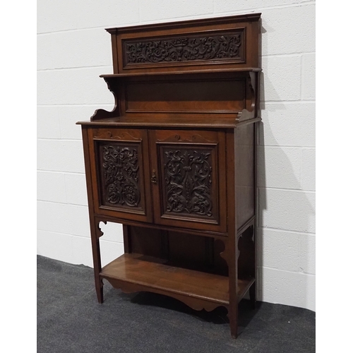 49 - Mahogany drinks cabinet with carved doors and shelves to the upper and lower section 61
