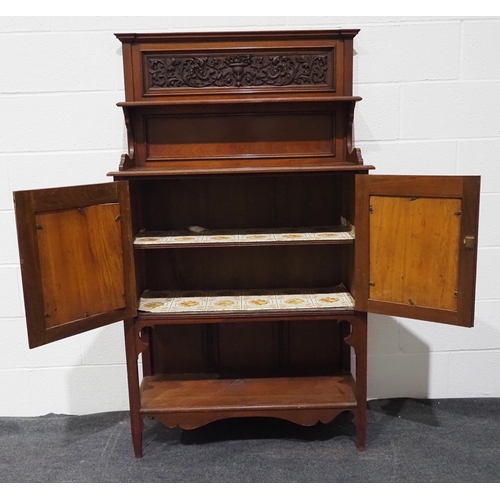 49 - Mahogany drinks cabinet with carved doors and shelves to the upper and lower section 61