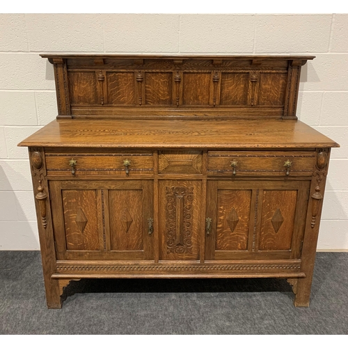 242 - Oak carved sideboard with brass drop handles, drawers, cupboards and keys 53