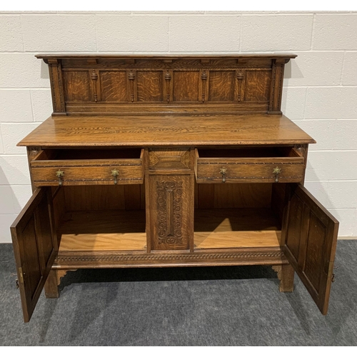 242 - Oak carved sideboard with brass drop handles, drawers, cupboards and keys 53