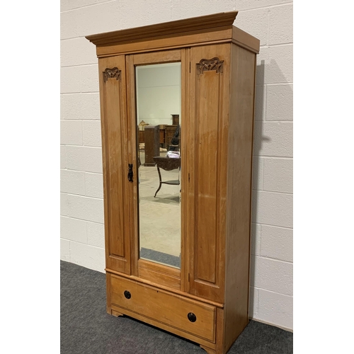 243 - Lightly carved satin wood wardrobe with bevel edge mirror and drawer 72