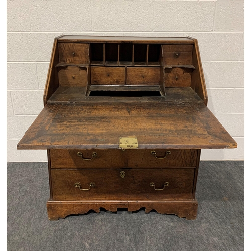 246 - Georgian oak bureau with fall front, well, 3 graduated drawers, brass handles and key 44