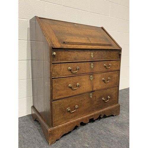 246 - Georgian oak bureau with fall front, well, 3 graduated drawers, brass handles and key 44