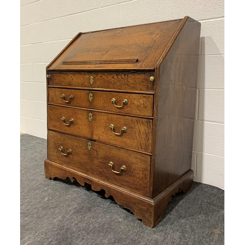 246 - Georgian oak bureau with fall front, well, 3 graduated drawers, brass handles and key 44