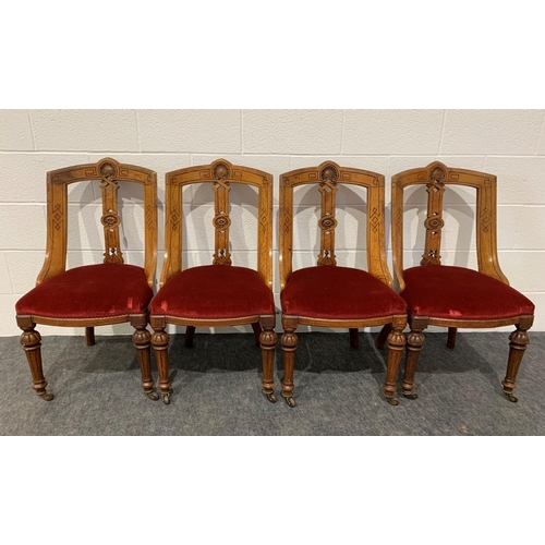 253 - Set of 4 carved oak chairs with red velvet seats on brass casters