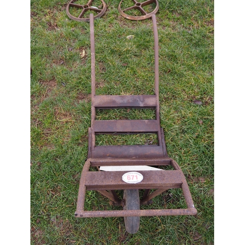 671 - Metal barrow and 4 cast iron wheels