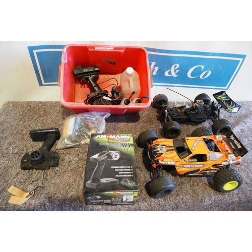 602 - 2 Nitro remote control cars and assorted controllers