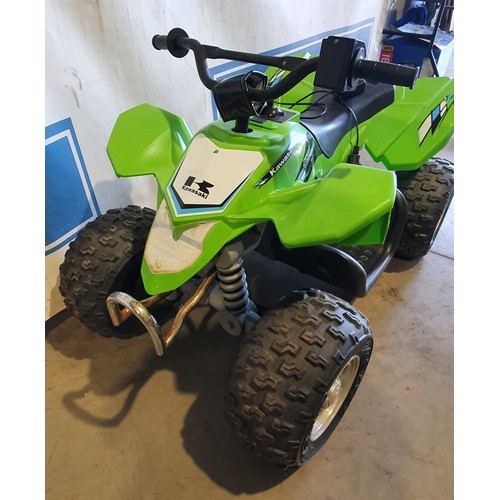 571 - Childs electric quad bike with Kawasaki logo, charger in office.