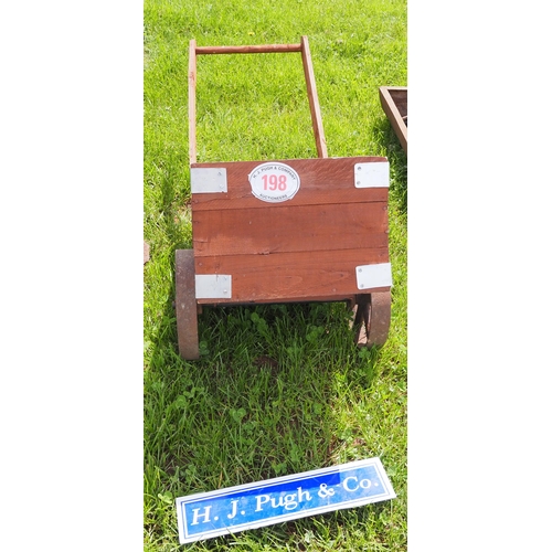 198 - Wooden barrow with cast iron wheels