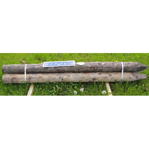 1061 - Peeled round stakes 7' x 5-6