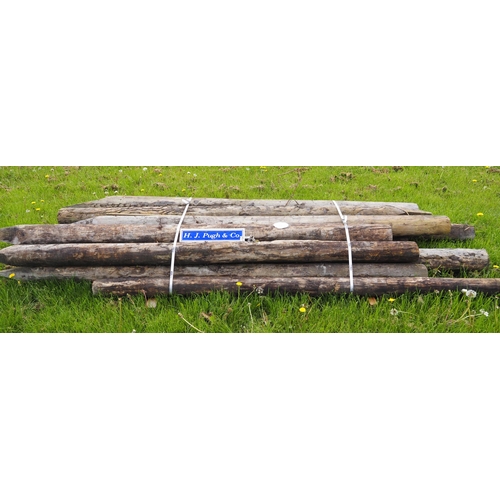 1062 - Peeled round stakes 10' x 7-8