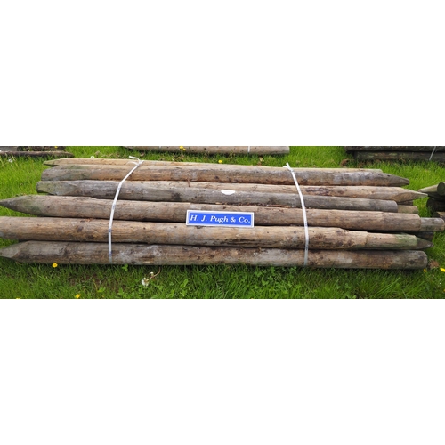 1063 - Peeled round stakes 10' x 6-7