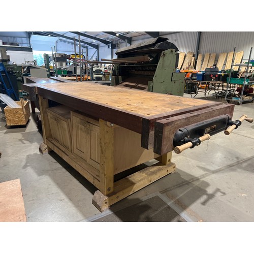 336 - Large wooden work bench with cupboards and 2 vices 99
