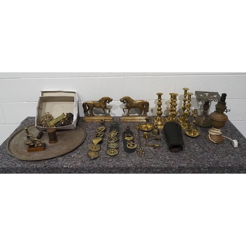 63 - Quantity of brass items to include door stops, oil lamp parts, tray etc.