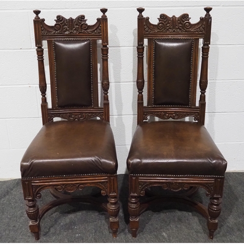 388 - Pair of heavily carved mahogany chairs with leather upholstered seats