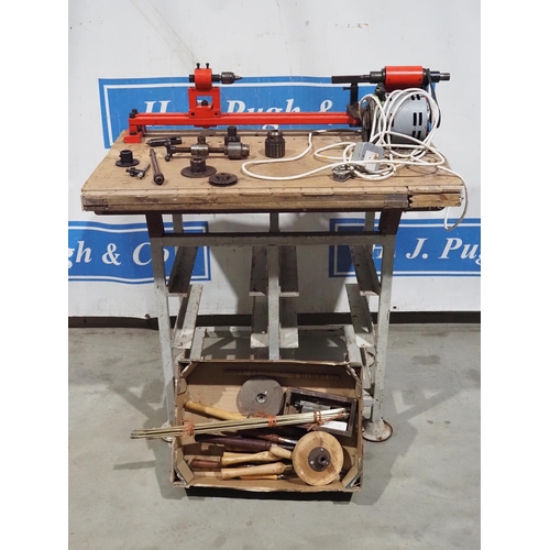 210 - Woodworking lathe on metal stand with assorted tools