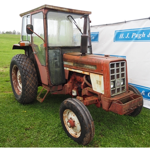 64 - IH 454 tractor. With cab, rear grass tyres, showing 5409 hours. Runs and drives.