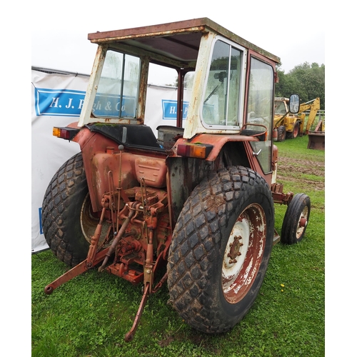 64 - IH 454 tractor. With cab, rear grass tyres, showing 5409 hours. Runs and drives.