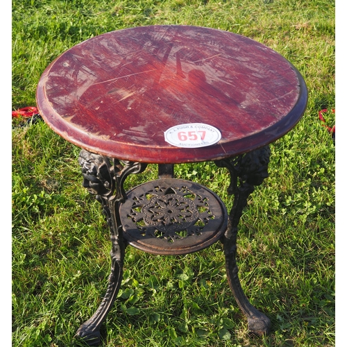 657 - Round wooden pub table with ornate cast iron base