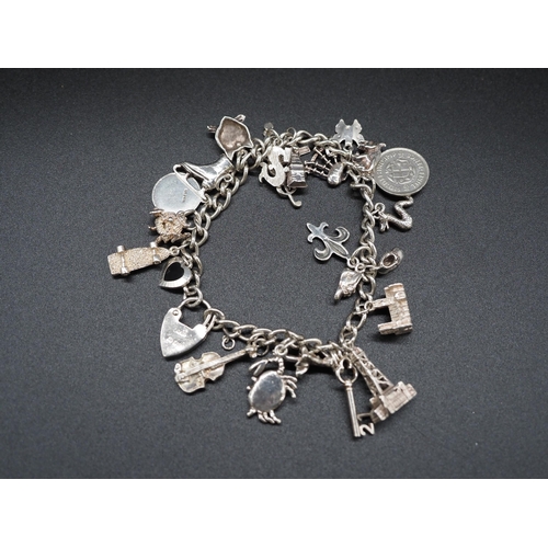 202 - Silver charm bracelet. Approx. 45.5g