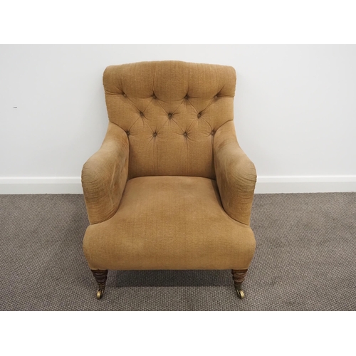 332 - Howard & Sons Ltd armchair. Sat on turned mahogany legs with stamped brass castors. This armchair ha... 