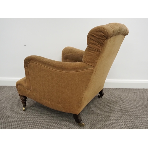 332 - Howard & Sons Ltd armchair. Sat on turned mahogany legs with stamped brass castors. This armchair ha... 