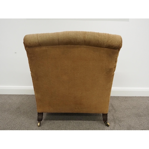 332 - Howard & Sons Ltd armchair. Sat on turned mahogany legs with stamped brass castors. This armchair ha... 