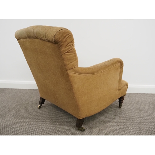 332 - Howard & Sons Ltd armchair. Sat on turned mahogany legs with stamped brass castors. This armchair ha... 