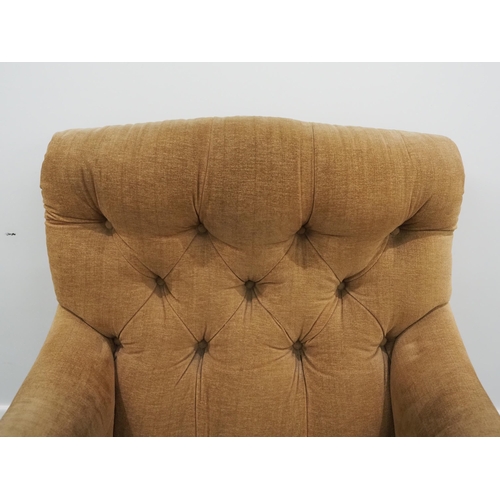 332 - Howard & Sons Ltd armchair. Sat on turned mahogany legs with stamped brass castors. This armchair ha... 