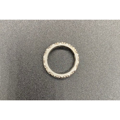 200A - A precious white metal diamond eternity ring, grain set 14 round brilliant-cut diamonds in carved a ... 