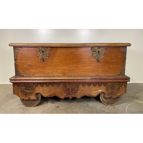 586 - Teak chest on wooden wheels with brass fittings H33