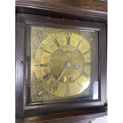 562 - 18th Century carved oak long case clock by Jonathan Lees of Bury with brass face H86