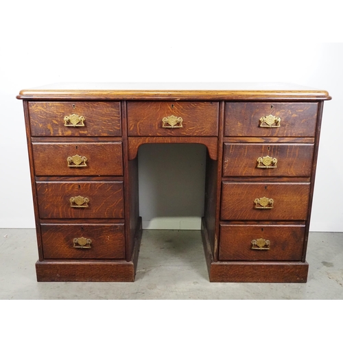 591 - Oak kneehole desk with 9 drawers H30