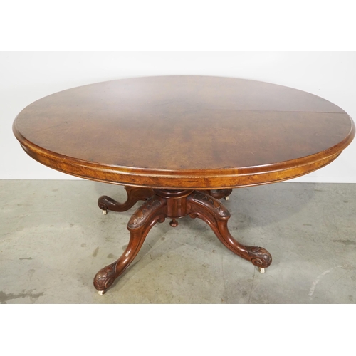 548 - Victorian walnut oval tilt top table on carved mahogany pedestal base H29