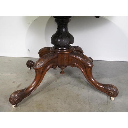 548 - Victorian walnut oval tilt top table on carved mahogany pedestal base H29