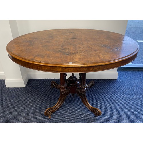 520 - Victorian burr walnut oval loo table on ornate 4 column base on casters. H29