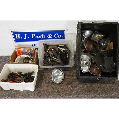 710 - Assorted motorcycle spares to include headlamps, springs, sprockets, etc.