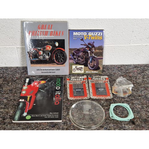 421 - Laverda spares to include brake pads, gaskets and headlamp glass, NOS and 3 motorcycle books