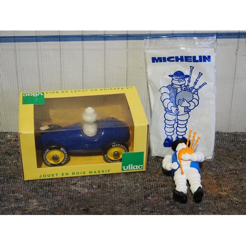 524 - Vilac Michelin man in car boxed and Michelin man with bag pipes in bag