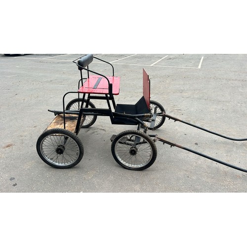 1024 - Red four wheeled carriage. Comes with 2 pairs of shafts, 1 pony and 1 horse