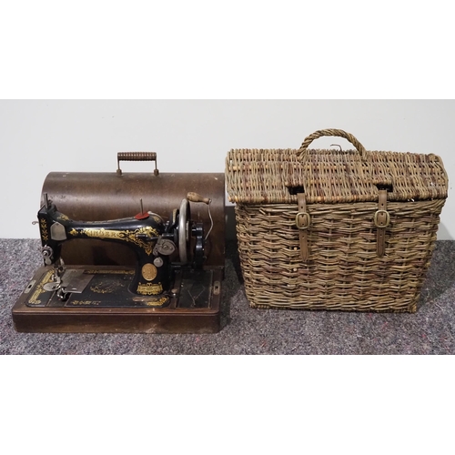 167 - Portable Singer sewing machine in case and wicker basket