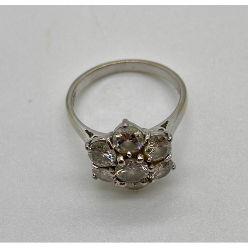 337A - 18ct White gold 7 stone diamond daisy cluster ring claw set. The center stone is approx. 50 points s... 