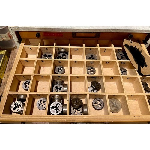 695 - Wooden 9 drawer unit and contents to include over 250 taps and dies in different sizes