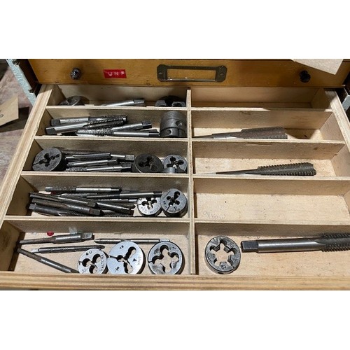 695 - Wooden 9 drawer unit and contents to include over 250 taps and dies in different sizes