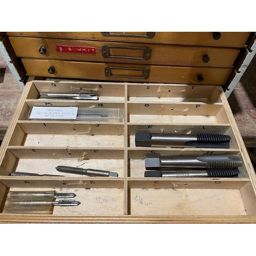 695 - Wooden 9 drawer unit and contents to include over 250 taps and dies in different sizes