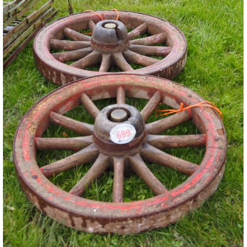 699 - Pair of cast wheels 36