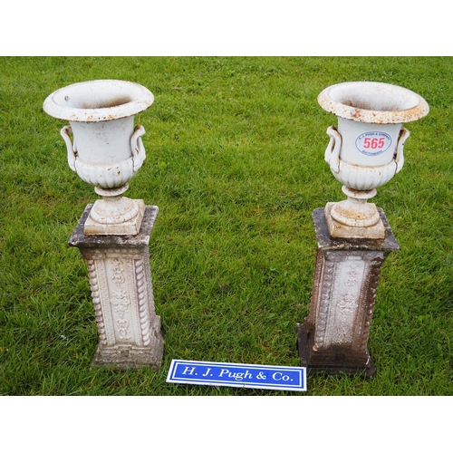 565 - Pair of cast iron urns on plinths 3ft max.