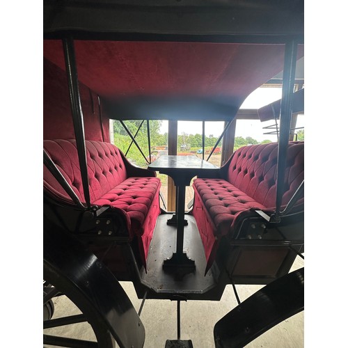 151 - Horse drawn 4 wheeled coach. Red upholstered seats and table