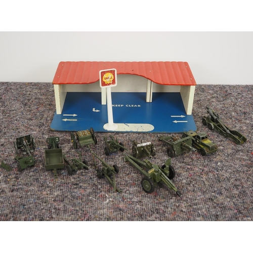 77 - Toy garage with toy military vehicles and cannons to include Crescent, Corgi and Meccano